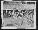 People in front of hut along waterfront