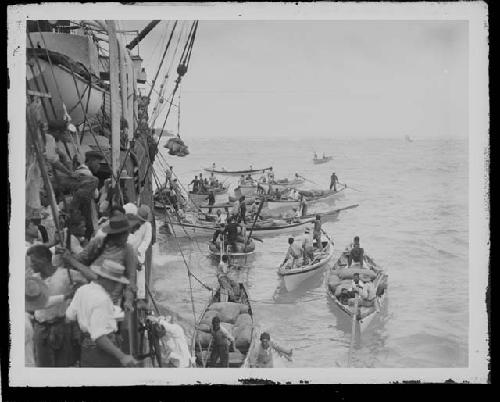 Men in canoes and boat