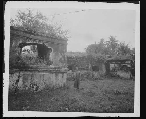 Man next to ruins in jungle setting