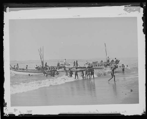 People working with boats in water