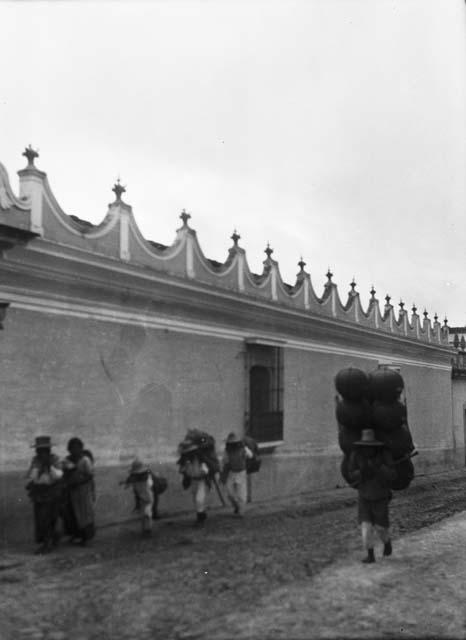 Guatemalan Indians walking by building