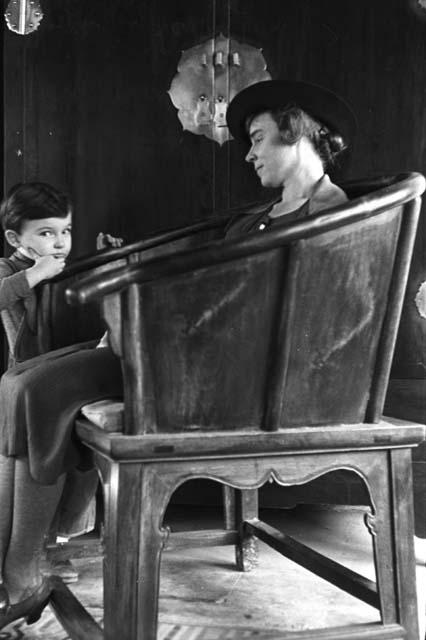 Eleanor, David, big wooden chair, our house