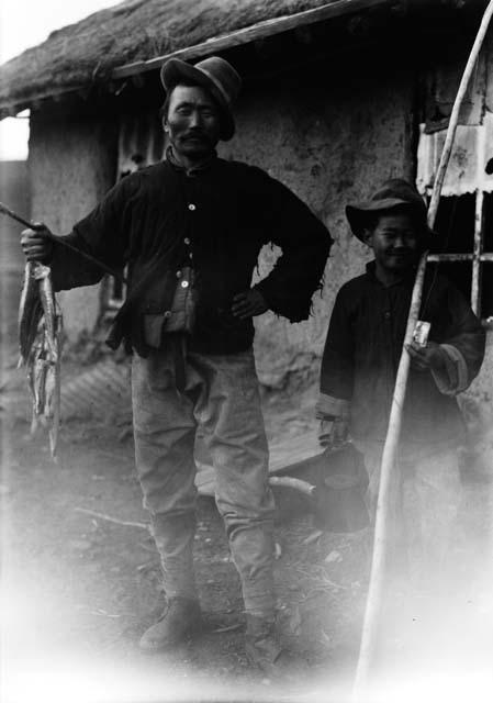 Man and boy with fishing poles and fish