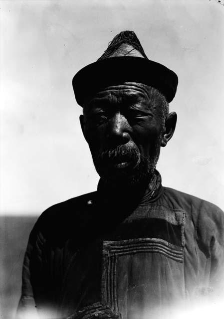 Portrait of an old man with a conical hat