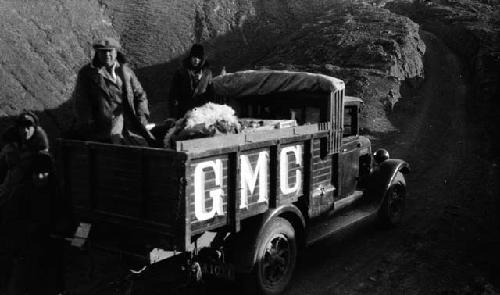 Four men in and around General Motors Company truck