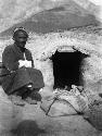 Man sitting beside entrance to winter care shelter