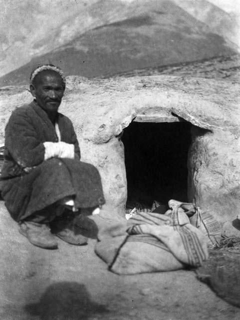 Man sitting beside entrance to winter care shelter