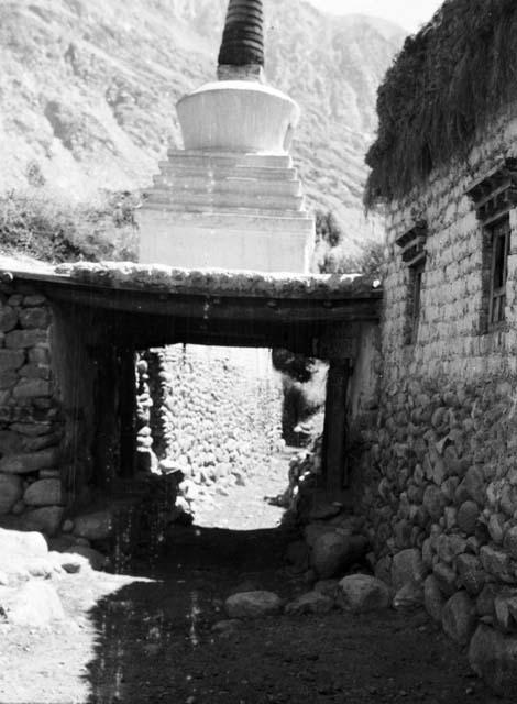 Chorten built on small bridge over path