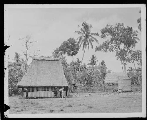 People in front of hut in rural setting