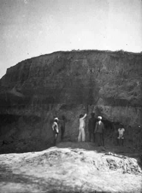 Men viewing stratigraphy on Cerro Sapote