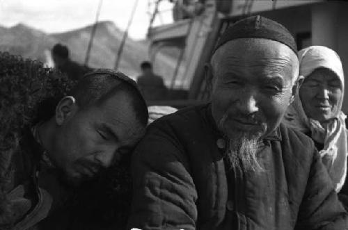 Same man and friend sleeping on shoulder