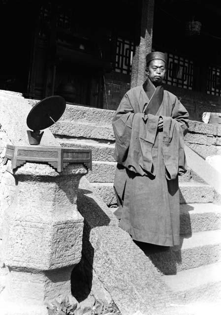 Taoist Priest descending steps of temple