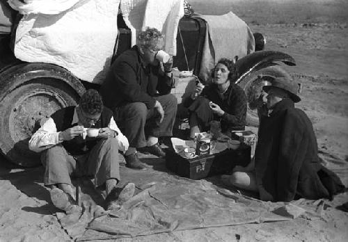 T. A. Bisson, Philip and Agnes Jaffe and Effie Hill sitting on blanket on ground