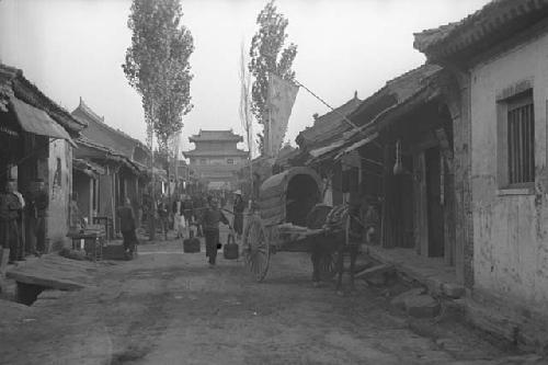 Street scene with buildings, people and horsecart