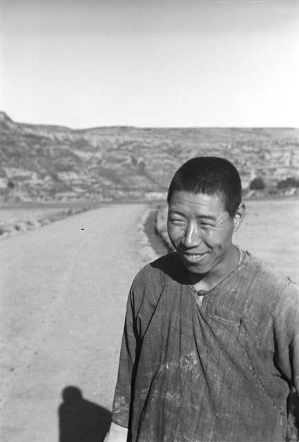 Man in front of long road