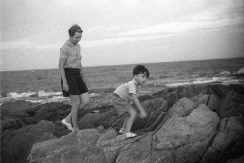 Elearnor and David Lattimore walking on rocks by seashore