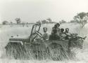 Daniel Blitz driving a Jeep with a group of Ju/'hoansi