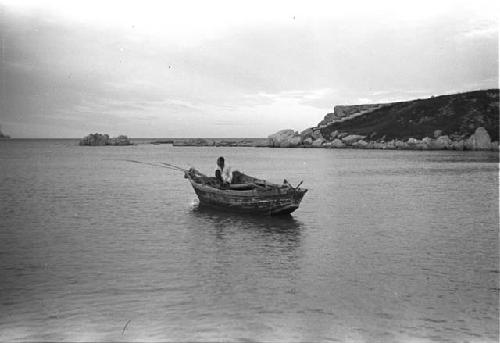 Person sitting boat fishing