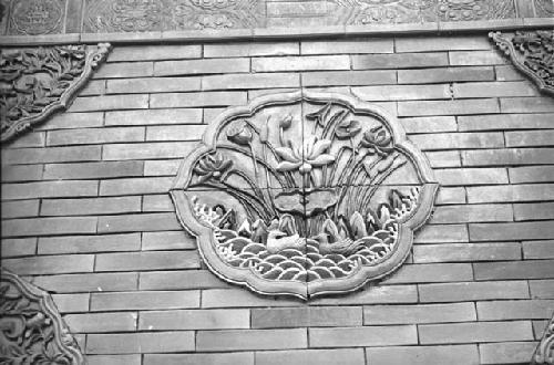 Close-up of carving with lotus on wall