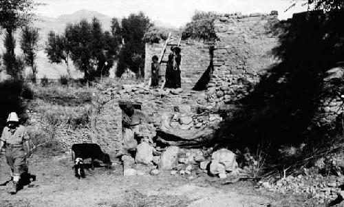 People on multi-level stone house