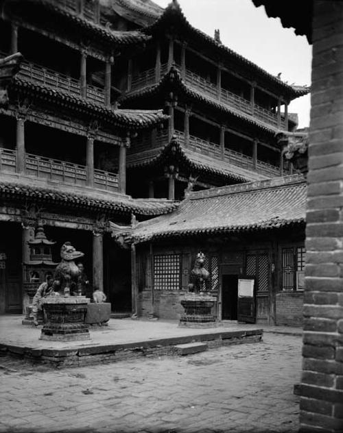 Temple with sculptures on pedestals in front