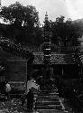 Two men and boy in courtyard by pagoda