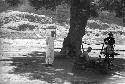 Four men under a tree with table and apparatus