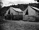 Dr. Brew and family by tents, Quemado camp