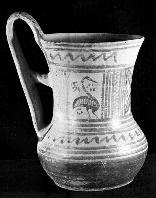 Pottery jug with high handle and bird painted on it