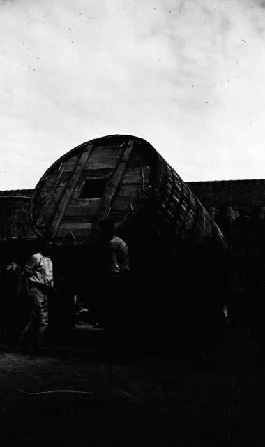 Men with large circular container