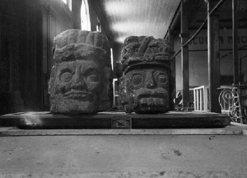 Two large, monumental stone heads