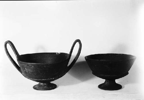 Two pottery dishes, one with large handles
