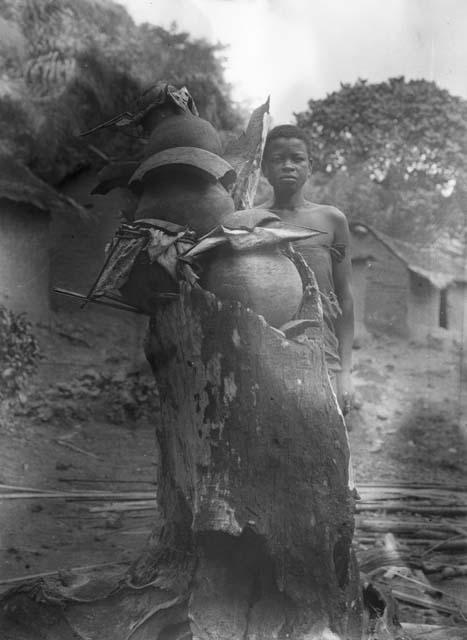 Boy showing method of storing seed