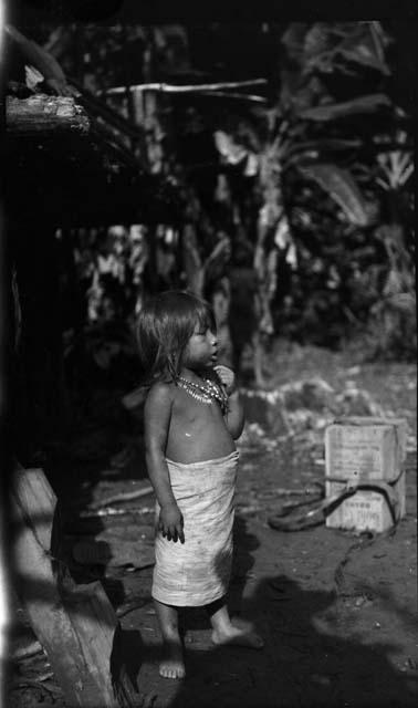 Small child in jungle setting