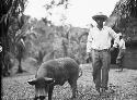 Antonio Saenez standing with pig