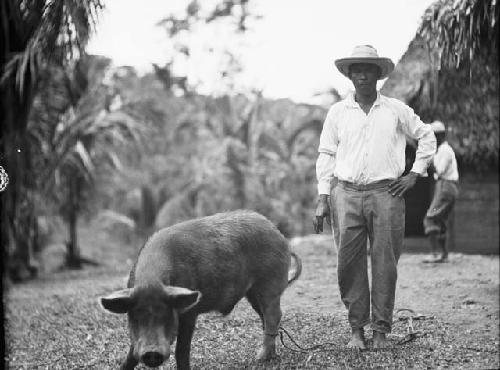 Antonio Saenez standing with pig