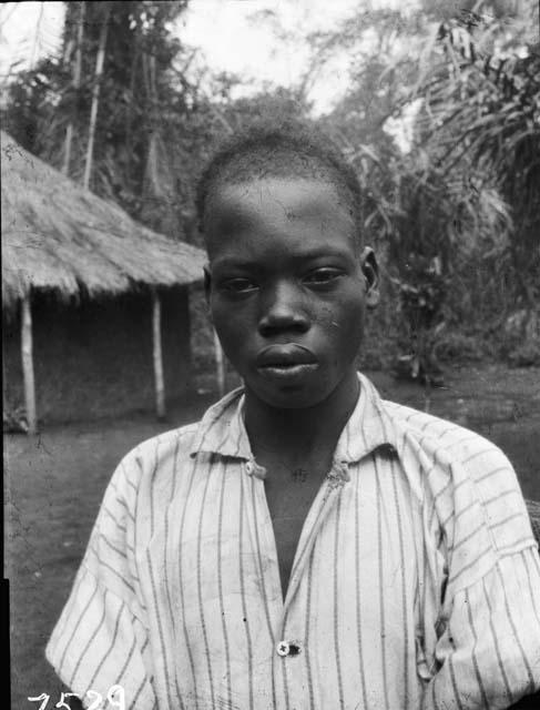 Young boy in front of hut