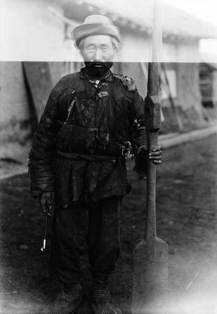 Portrait of an old man with an oar and a pipe