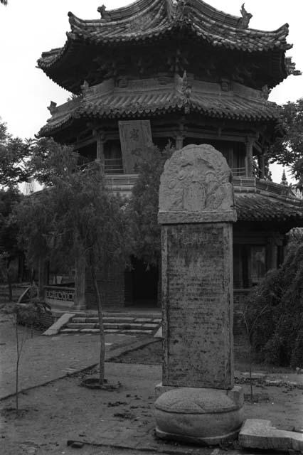 Carved stone tablet in foreground