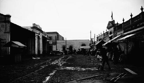 People walking through street, vendors in stalls