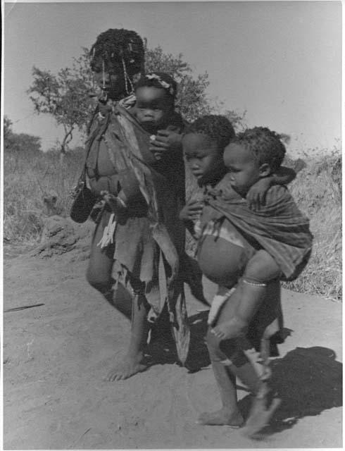 "Carrying children": Be and ≠Gisa carrying babies tied in their karosses (print is a cropped image)