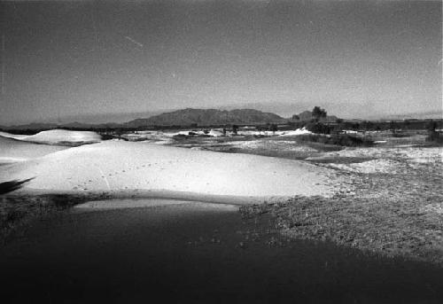 Sand dunes with lake in foreground