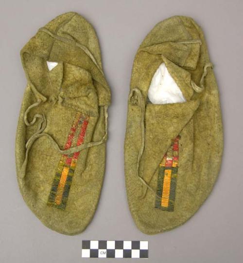 Pair of moccasins, probably Sioux. Rawhide soles, soft bison hide uppers