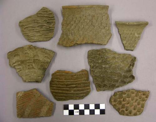 Ceramic sherds, corrugated body and rim, some from jar