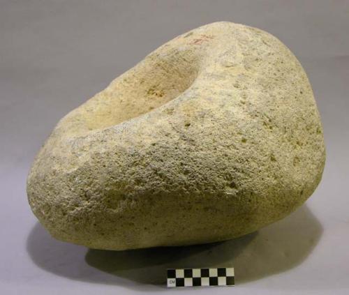 Mortar. irregular small boulder. with conical, deep depression in center of one