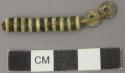 Beads, white shell and tortoise shell discoidal beads, on fiber