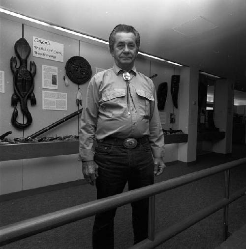 Joe Johns in front of his exhibit Cayoni, Traditional Creek Woodcarving