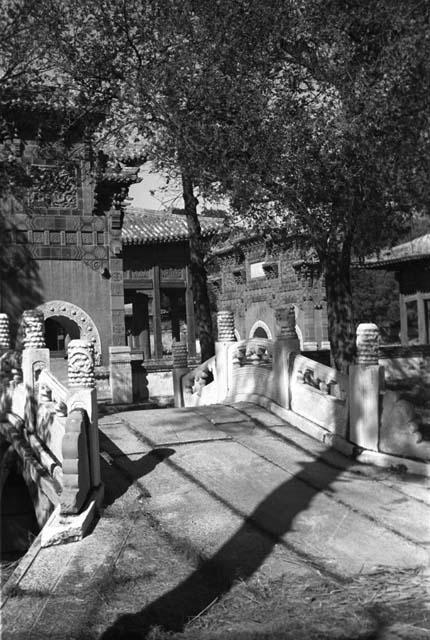 Small stone bridge leading to gateway with three arches