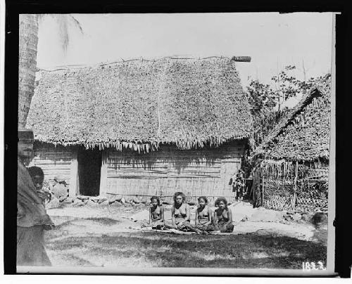 Four women outside of hut