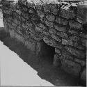 Entrance into stone lined side cist under south bench in east room